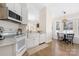 Open kitchen with white cabinets, modern appliances, and a view to the breakfast nook at 5616 Ebley Ln, Charlotte, NC 28227