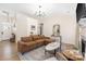 Bright living room with large sectional sofa, fireplace, and hardwood floors at 5616 Ebley Ln, Charlotte, NC 28227