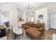 Open-concept living room with comfortable seating and seamless flow into the kitchen area at 5616 Ebley Ln, Charlotte, NC 28227
