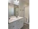 Bathroom featuring a double sink vanity, a large mirror, and a glass door shower at 565 Perry Rd, Troutman, NC 28166