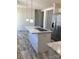 Modern kitchen island featuring a stainless steel sink, faucet, and elegant marble countertops at 565 Perry Rd, Troutman, NC 28166