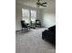 Cozy living room with plush gray carpeting, natural light, and modern furniture at 565 Perry Rd, Troutman, NC 28166