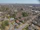 Aerial view of neighborhood featuring a pool, road and mature trees at 634 Carolina Ave, Gastonia, NC 28052