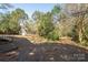 Backyard featuring a garage, mature trees, and a swing set at 634 Carolina Ave, Gastonia, NC 28052
