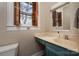 Bathroom vanity with a blue base cabinet, drop-in sink, wood window shutters and medicine cabinet at 634 Carolina Ave, Gastonia, NC 28052
