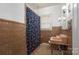 A peach-toned vintage bathroom features a floral shower curtain, tiled walls, and a window at 634 Carolina Ave, Gastonia, NC 28052