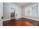 A bedroom offers wood floors, neutral paint, a window, and access to the bathroom at 634 Carolina Ave, Gastonia, NC 28052