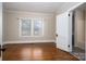 Bedroom showcasing hardwood floors, neutral walls, and a window with bright light and a door to the bathroom at 634 Carolina Ave, Gastonia, NC 28052