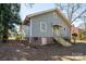 Side of house showing light blue siding, brick foundation, stairs, and landscaping at 634 Carolina Ave, Gastonia, NC 28052