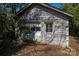 Exterior of old garage showing peeling paint and mature trees at 634 Carolina Ave, Gastonia, NC 28052