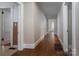 Long hallway with hardwood floors and doors leading to various rooms in the home at 634 Carolina Ave, Gastonia, NC 28052