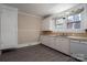 A vintage kitchen features white cabinets, a double sink, and wood-look flooring at 634 Carolina Ave, Gastonia, NC 28052