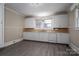 A vintage kitchen features white cabinets, a double sink, and wood-look flooring at 634 Carolina Ave, Gastonia, NC 28052