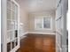 Hardwood floors and a fireplace with french doors enhance this bright and neutral living room at 634 Carolina Ave, Gastonia, NC 28052