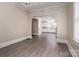 A living room area has gray floors and flows to a kitchen area and great natural light at 634 Carolina Ave, Gastonia, NC 28052