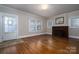 Bright living room features hardwood floors, neutral paint, and a brick fireplace at 634 Carolina Ave, Gastonia, NC 28052