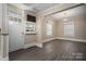 Bright living room features wood-look flooring, two windows and an elegant chandelier at 634 Carolina Ave, Gastonia, NC 28052