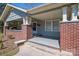 The inviting porch features brick columns, a cozy bench and space for relaxing or entertaining at 634 Carolina Ave, Gastonia, NC 28052