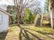 Spacious backyard featuring a shed, mature trees, and a wooden deck with stairs, perfect for outdoor enjoyment at 707 Oakshade Ave, Kannapolis, NC 28083