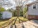 Spacious backyard featuring a storage shed, access to a deck with stairs, and mature trees providing ample shade at 707 Oakshade Ave, Kannapolis, NC 28083
