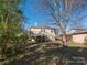 Expansive backyard features a deck, access stairs, a storage shed, and an abundance of mature trees for privacy at 707 Oakshade Ave, Kannapolis, NC 28083