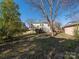 Expansive backyard features a deck, access stairs, a storage shed, and an abundance of mature trees for privacy at 707 Oakshade Ave, Kannapolis, NC 28083