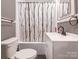 Functional bathroom with a toilet, vanity, and shower/tub combination with a decorative curtain at 707 Oakshade Ave, Kannapolis, NC 28083
