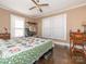 Bright bedroom with hardwood floors, a bed with a colorful quilt, and natural light at 707 Oakshade Ave, Kannapolis, NC 28083