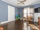 Bedroom featuring original hardwood floors and large windows with a ceiling fan at 707 Oakshade Ave, Kannapolis, NC 28083