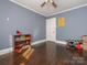 Bedroom showcasing dark hardwood floors and natural light that fills the room at 707 Oakshade Ave, Kannapolis, NC 28083