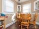 Inviting dining area features a wood table, complemented by natural light from the windows at 707 Oakshade Ave, Kannapolis, NC 28083