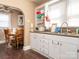 Bright kitchen with white cabinets, laminate countertops, and an adjacent dining area at 707 Oakshade Ave, Kannapolis, NC 28083
