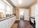 Functional kitchen featuring white cabinets, wood-look floors, and essential appliances at 707 Oakshade Ave, Kannapolis, NC 28083