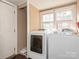 Bright laundry area with modern white washer and dryer set, offering convenience and efficiency at 707 Oakshade Ave, Kannapolis, NC 28083