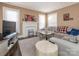 Cozy living room with hardwood floors, a decorative fireplace, and ample natural light from the windows at 707 Oakshade Ave, Kannapolis, NC 28083