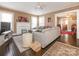 Comfortable living room with a large sectional sofa, stylish decor, and access to other rooms at 707 Oakshade Ave, Kannapolis, NC 28083