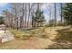 Expansive backyard featuring a charming fire pit and lush landscaping, perfect for outdoor entertaining at 7815 Ambleside Dr, Charlotte, NC 28216
