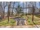 Cozy backyard fire pit area with a unique wooden frame, perfect for relaxation and gatherings at 7815 Ambleside Dr, Charlotte, NC 28216