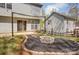 Outdoor living enhanced by a firepit and patio adjacent to the house with a sliding door entrance at 7815 Ambleside Dr, Charlotte, NC 28216