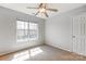 Bedroom featuring a ceiling fan, natural light from the window, and neutral colored walls at 7815 Ambleside Dr, Charlotte, NC 28216