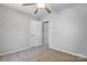 Neutral bedroom with a ceiling fan and an open door to a closet and additional space at 7815 Ambleside Dr, Charlotte, NC 28216