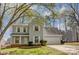 Charming two-story home featuring light blue siding, white shutters, and a well-manicured lawn, framed by tree branches at 7815 Ambleside Dr, Charlotte, NC 28216