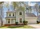 Charming two-story home featuring light blue siding, white shutters, a brick foundation and a well-manicured lawn at 7815 Ambleside Dr, Charlotte, NC 28216