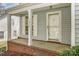Close-up of the front porch, featuring a brick base, white columns, and the house number 7815 on the side at 7815 Ambleside Dr, Charlotte, NC 28216