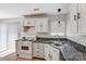 Bright kitchen features white cabinetry, stainless sink, and ample counter space for meal preparation at 7815 Ambleside Dr, Charlotte, NC 28216