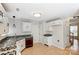 Well-lit kitchen featuring white cabinets, wood-look floors, modern appliances, and contrasting countertops at 7815 Ambleside Dr, Charlotte, NC 28216