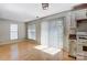 Sunlit living area with bright windows, light wood floors, and direct access to the kitchen at 7815 Ambleside Dr, Charlotte, NC 28216