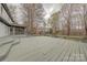 Spacious deck with a gray stain overlooking a backyard at 10101 Woodview Cir, Charlotte, NC 28277