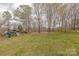 A backyard features a large grassy area, complemented by a play set and a wooden split rail fence at 10101 Woodview Cir, Charlotte, NC 28277