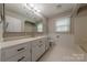 Bathroom features a large vanity, mirror, and tiled floor at 10101 Woodview Cir, Charlotte, NC 28277